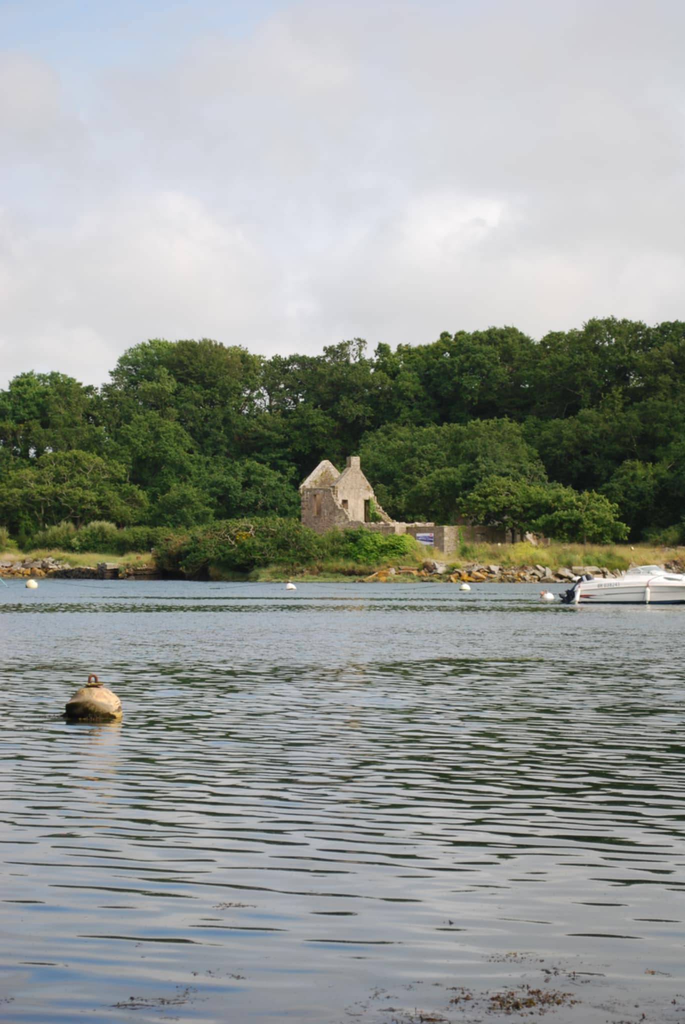 Côte rocheuse bretonne avec vagues frappant les falaises sous un ciel orageux